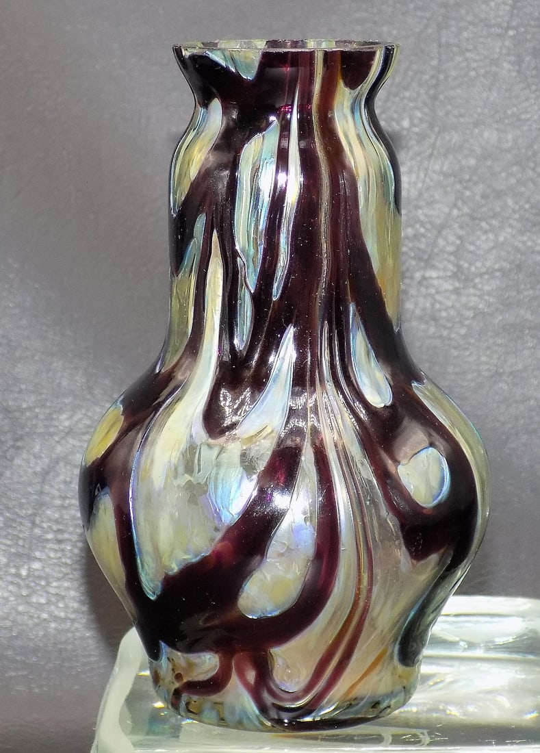 Vintage Loetz style art glass vase: Vintage Loetz style art glass vase. Beautiful colors and design. Nice iridescence. Hand blown. Has roughness on top rim as shown in photos. 5 3/8 inches tall