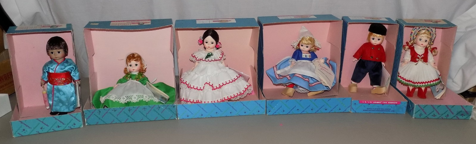 Six Vintage Madame Alexander International dolls: Six Vintage Madame Alexander International dolls . Ireland 578. Netherlands 591. Panama 555. Netherland Boy 577. Japan 570. Hungary 597. Beautiful colors. Great quality and detail. Looks to be never p