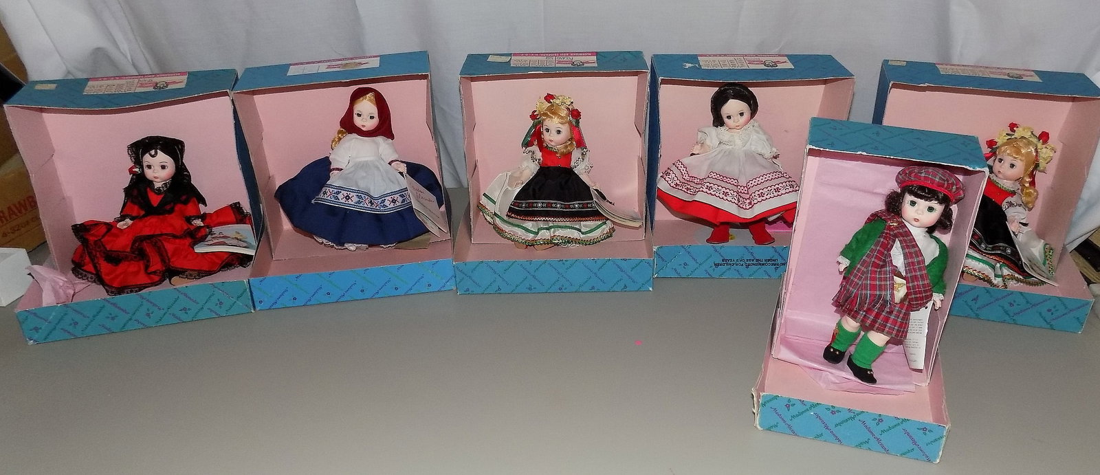 Six Vintage Madame Alexander International dolls: Six Vintage Madame Alexander International dolls . Scotland 596. Russia 548. Spain 595. Two Poland dolls numbered 580. Russia 514. Beautiful colors. Great quality and detail. Looks to be never played 