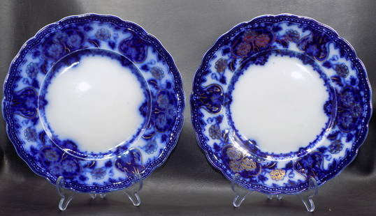 Beautiful pair of Flow Blue dinner plates with gold highlights: Beautiful pair of Flow Blue dinner plates with gold highlights. Great quality and detail. Marked on back Wood and Son as shown in photo. One plate has a chip on backside as shown in photo. 9 inch diam