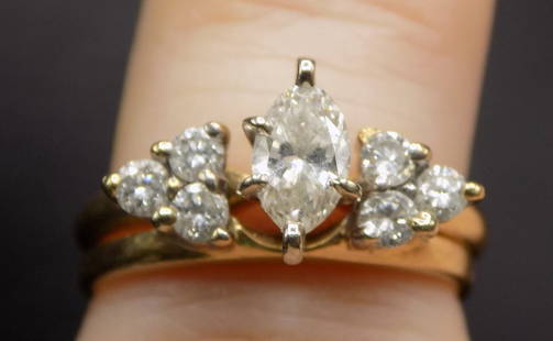 Beautiful 14k gold and diamond ring: Beautiful 14k gold and diamond ring. Two separate rings that interlock as shown in photo. Marked as shown in photo. Great quality and detail. One center diamond surrounded by six small diamonds. Size