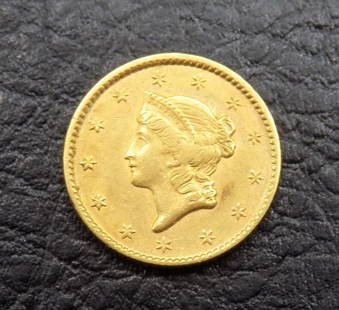 Higher grade 1851 Liberty Head one dollar gold coin: Higher grade 1851 Liberty Head one dollar gold coin. Please see photos to grade for yourself. Please use photos to grade. All gold coins must be paid through Live Auctioneer or bank to bank wire trans