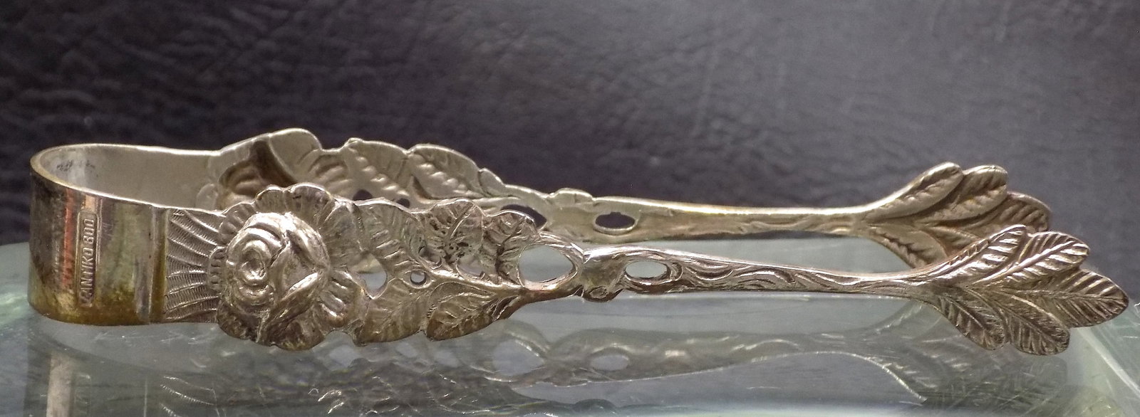 Onate vintage 800 silver sugar tongs: Onate vintage 800 silver sugar tongs. Floral decorated. Marked 800 as shown in photos. In very good original as found condition. Great quality and detail. 3 7/8 inches long
