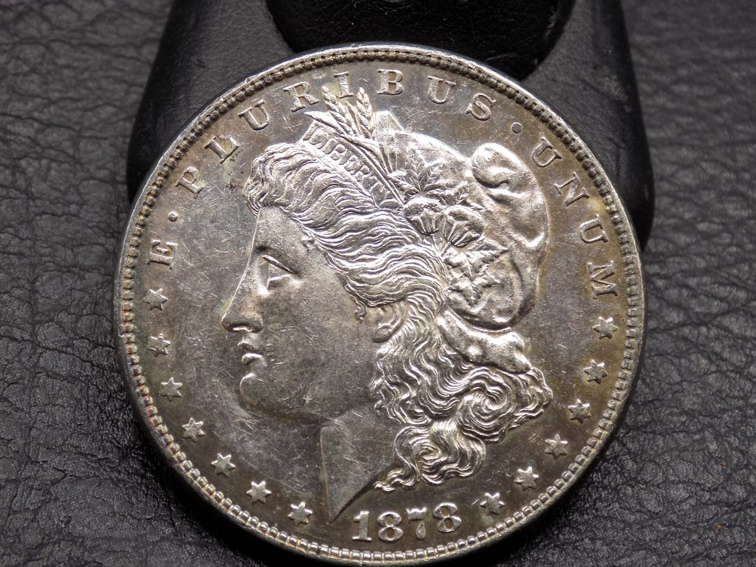 Uncirculated 1878 eight tail feather Morgan silver dollar. (1 of 3)