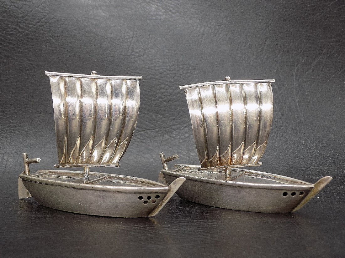 Ornate vintage Oriental sterling salt and pepper shakers: Ornate vintage Oriental sterling salt and pepper shakers. In shape of sail boats. Very good original as found condition. Great quality and detail. Marked sterling on bottom as shown In photo. 2 inches