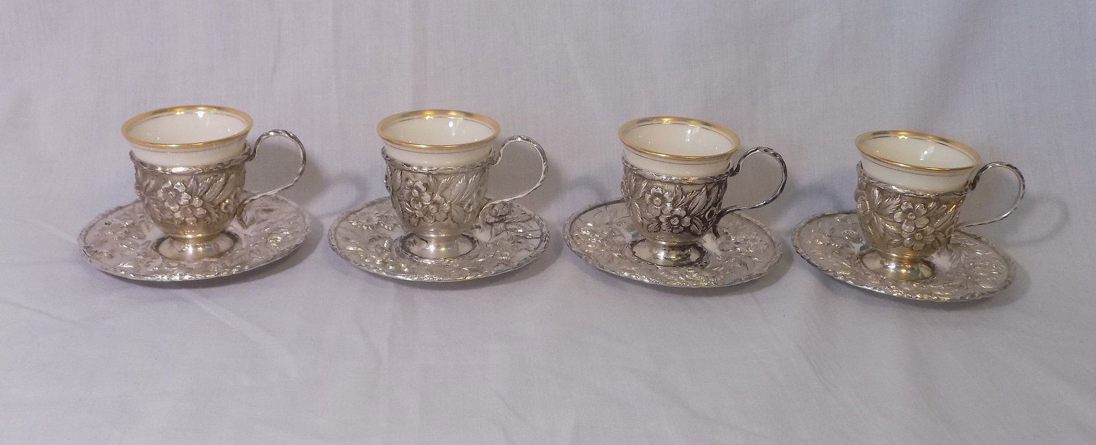 Fabulous set of four S. Kirk and Son Repousse demitasse cups with saucers: Fabulous set of four S. Kirk and Son Repousse demitasse cups with saucers. Marked on bottom as shown in photos. No condition problems. Has some tarnish, normal from age, and is easily polished. Has on