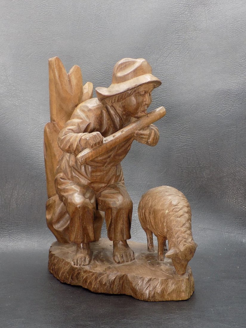 Nice vintage Black Forest carving with man and sheep: Nice vintage Black Forest carving with man and sheep. Man is playing an instrument. Great quality and detail. Original finish. 9 inches tall. Base 7 x 4 inches