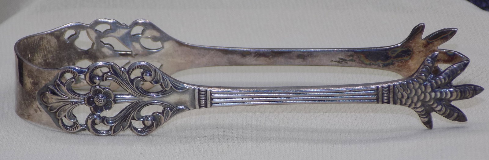 Vintage sterling silver sugar tongs: Vintage sterling silver sugar tongs. Marked IH. Marihinsen Sterling Norwayas shown in photo. Great quality and detail. 3 ½ inches long. In very good original as found condition.
