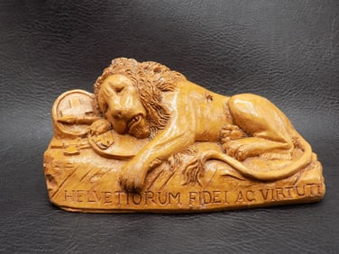 Vintage carved reclining lion.