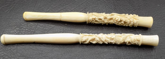 Two vintage highly carved Oriental cigarette holders with dragons