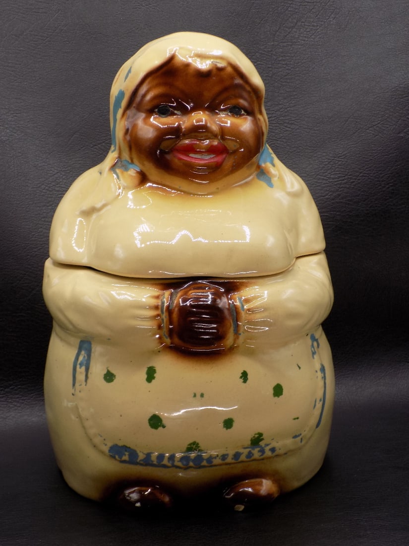 Vintage Black Americana cookie jar Mammy: Vintage Black Americana cookie jar Mammy. Marked on bottom as shown in photo. Porcelain. Has small chip on foot as shown in photo. Normal from use and age. 9 ½ inches tall