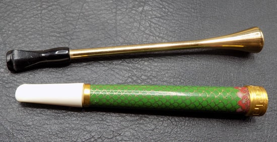 Two vintage cigarette holders. One is cloisonne