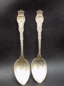 Great pair of antique sterling serving spoons with cupids