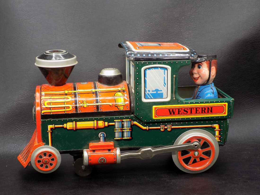 Vintage Western battery-operated tin toy train: Vintage Western battery-operated tin toy train. Marked Made in Japan as shown in photos. Great quality and detail. Beautiful colors. Takes two C batteries. 11 inches long x 6 3/4 inches tall