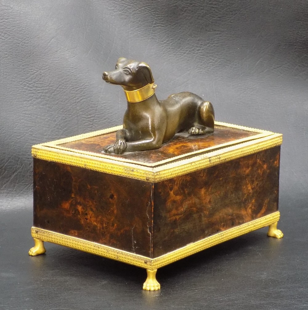 Unique antique footed jewelry box with dog on lid: Unique antique footed jewelry box with dog on lid. Box looks to be burled wood with brass or bronze mounting. Clawfeet. Metal dog with original patina. Great quality and detail. In very good original 