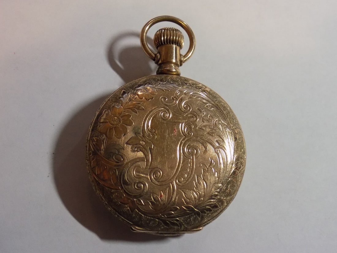 Fancy antique gold-filled hunting case Elgin pocket: Fancy antique gold-filled hunting case Elgin pocket watch. Running. Engraved. Porcelain dial. Please see photos for serial numbers. 1 5/8 inches wide