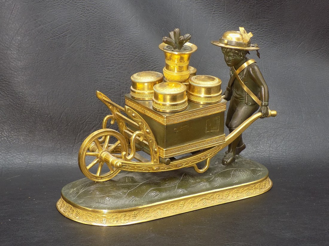 Rare antique figural multi-inkwell. Child pushing wheelbarrow: Rare antique figural multi-inkwell. Child pushing wheelbarrow. Looks like bronze. Two of the holders have glass containers. We have never seen or had another like this! Great quality and detail. In ve