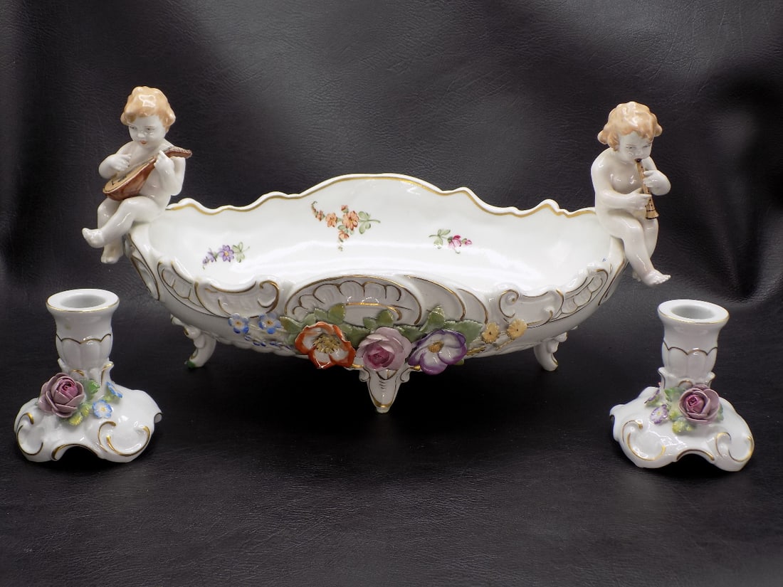 Magnificent Capodimonte center bowl and candlesticks: Magnificent Capodimonte center bowl and candlesticks. Cupids playing instruments sitting on bowl. Floral decorations. Marked on bottom as shown in photos. Great quality and detail. In very good origin