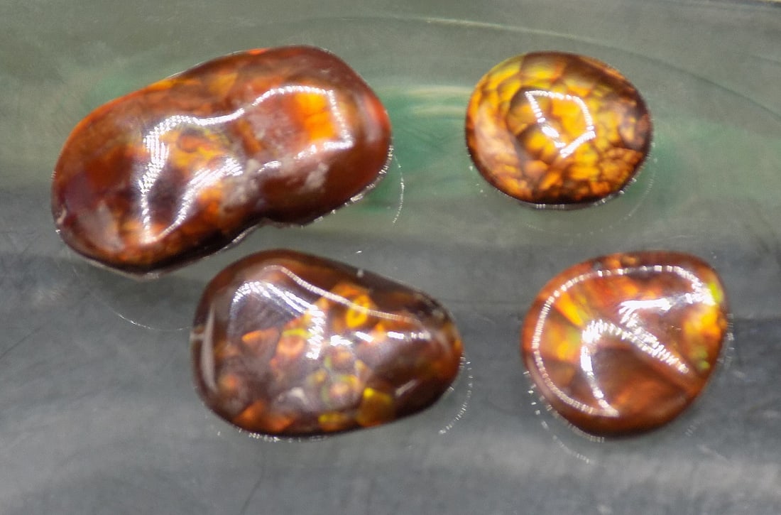 Four beautiful fire agate gemstones: Four beautiful fire agate gemstones. Approximately 10 cwt