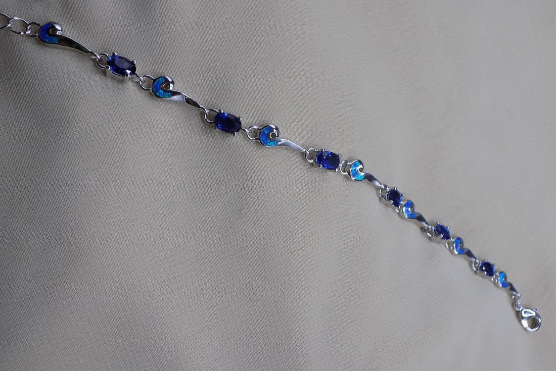 Beautiful 4 ct. sapphire and Australian opal Sterling tennis bracelet.: Beautiful 4 ct. sapphire and Australian opal Sterling tennis bracelet. 7 inches long marked 925