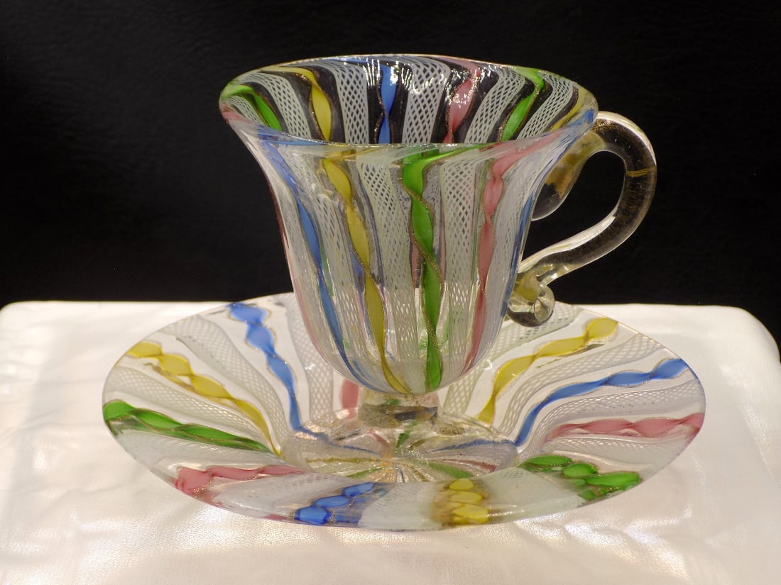 Beautiful midcentury Murano art glass cup and saucer: Beautiful midcentury Murano art glass cup and saucer. Latticino ribbon glass with gold dust twist in rainbow colors. Great quality and detail. In very good original as found condition. Please see phot