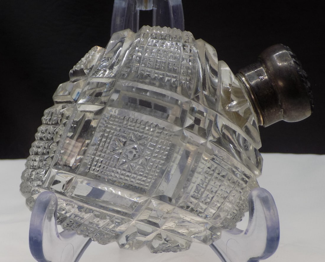 Antique American brilliant cut glass lay down perfume bottle: Antique American brilliant cut glass lay down perfume bottle. Marked sterling on rim as shown in photo. In very good original as found condition. Great quality and detail. 4 inches long x 3 inches wid