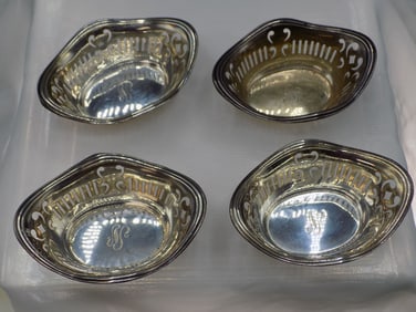 Four ornate vintage sterling silver nut dishes