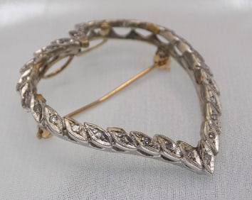 Heart shaped 14k white and yellow gold broach with twenty seven diamonds
