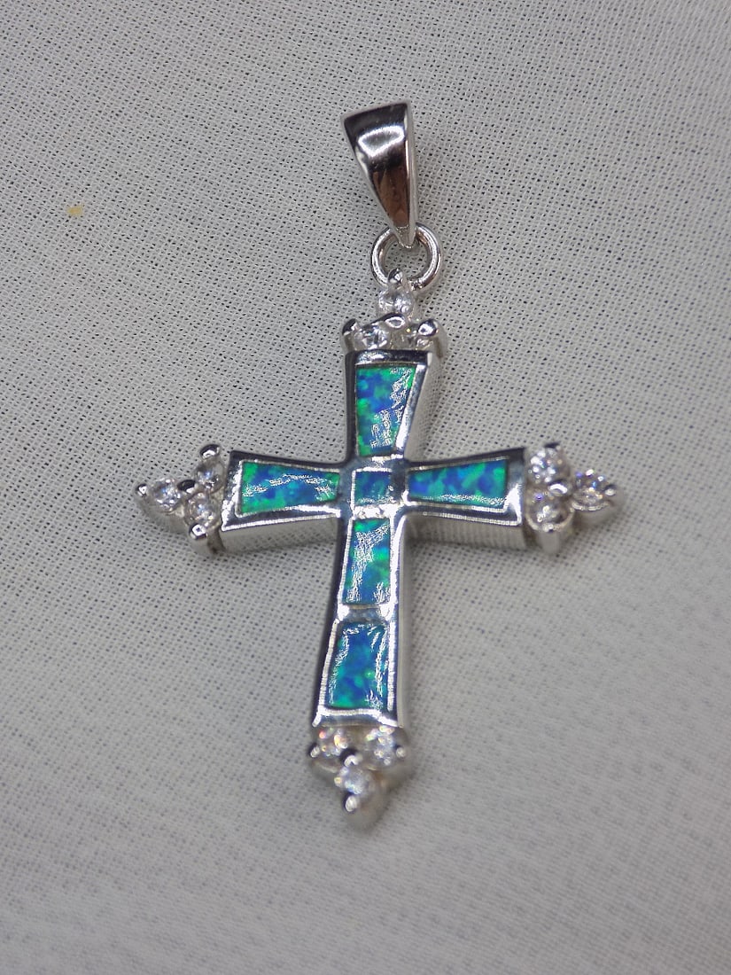 Beautiful Australian opal inlaid sterling silver cross: Beautiful Australian opal inlaid sterling silver cross. Height 1 inch.
