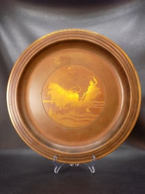 Antique bronze charger or tray with overlay scene of bulls and woman plowing field.