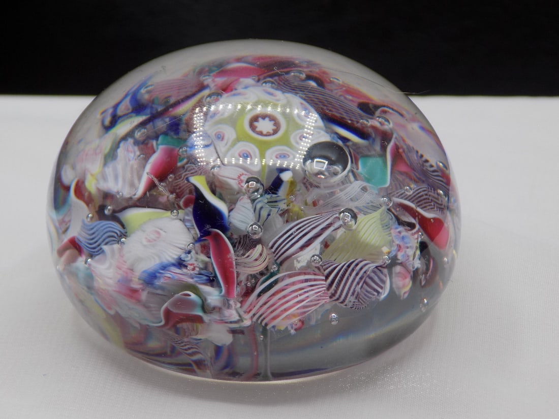 Fabulous vintage millefiori and ribbon glass art glass paperweight: Fabulous vintage millefiori and ribbon glass art glass paperweight. Beautiful colors. Great quality and detail. In very good original as found condition. White dotted light is camera reflection. 1 5/8