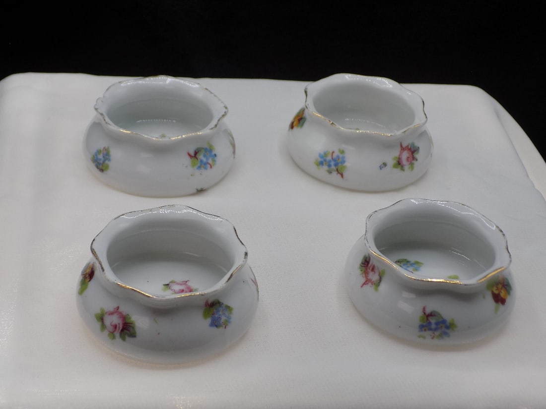 Antique set of four Royal Austria salt dips: Antique set of four Royal Austria salt dips. Decorated with roses. Beautiful colors. Great quality and detail. In very good original as found condition. 7/8 inches tall x 2 inches wide.