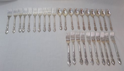 Thirty Heirloom Oneida Grandeur sterling silver flatware pieces.