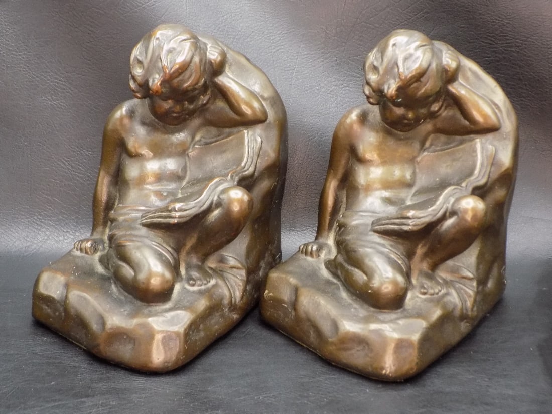 Antique Armor Cupid Bookends.: Antique Armor Cupid Bookends. Bronze over plaster. Marked S. Morani and tag on bottom as shown in photo. Original patina. Great quality and detail. 6 ¼ inches tall. 4 ½ wide x 5 ¾ long