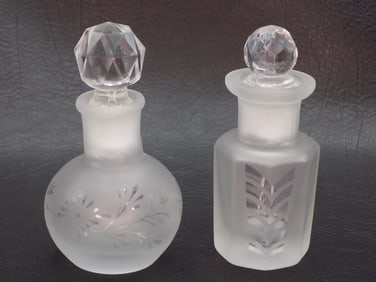 Two vintage decorated glass perfume bottles.