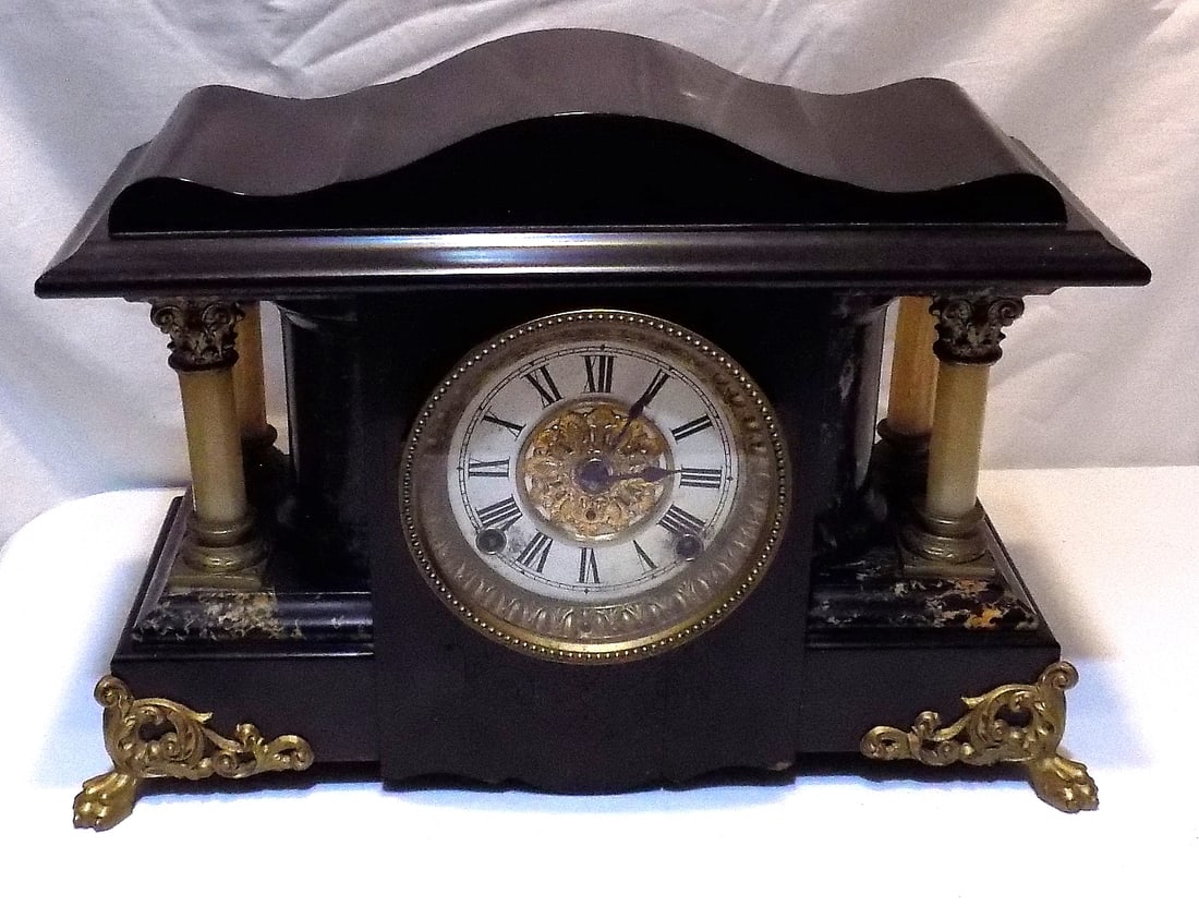 Nice looking American antique mantle clock: Nice looking American antique mantle clock. In good condition and running at time of listing. Marked made in America. Beautiful colors. Great quality and detail. 11 ¾ inches tall and 6 wide.Mar