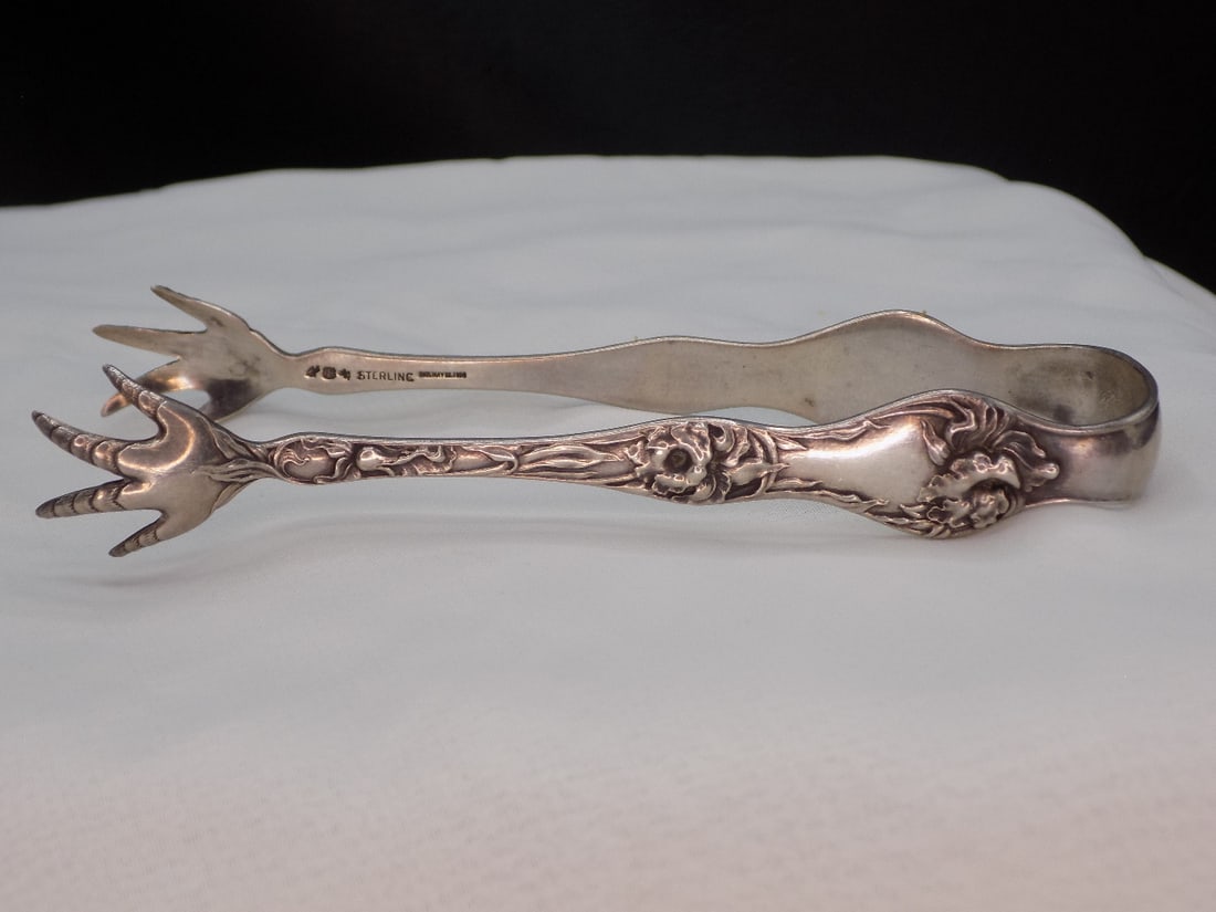 Vintage sterling silver sugar tongs: Vintage sterling silver sugar tongs. Marked and dated 1898 Sterling as shown in photo. Great quality and detail. In very good original as found condition. 4 3/8 inches long. 26 grams