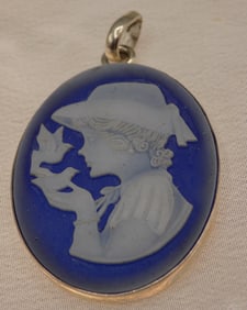 Italian cameo style pendant with girl holding bird in hand.