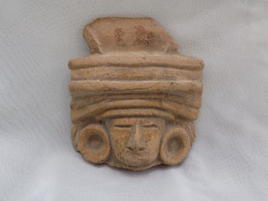 Ancient pre Colombian artifact face figure.