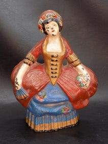 Antique cast iron door stop of lady with flowers
