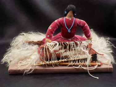 Splendid vintage Native American Indian doll weaving a rug.