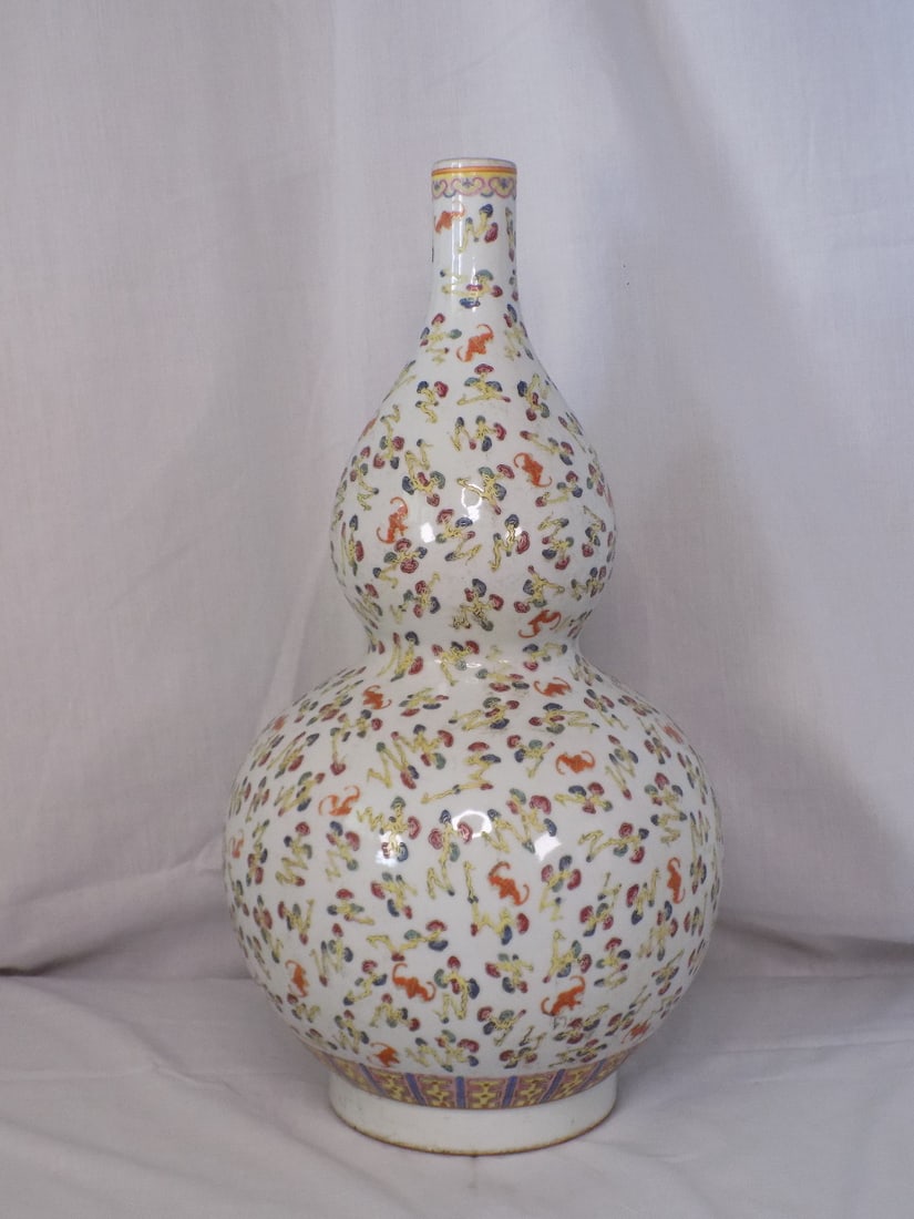 Beautiful Qianlong marked Famille Rose porcelain vase.: Beautiful Qianlong marked Famille Rose porcelain vase. Marked on bottom as shown in photo. Decorated with bats among clouds. Beautiful colors. Great quality and detail. 19 inches tall x 9 ½ at 