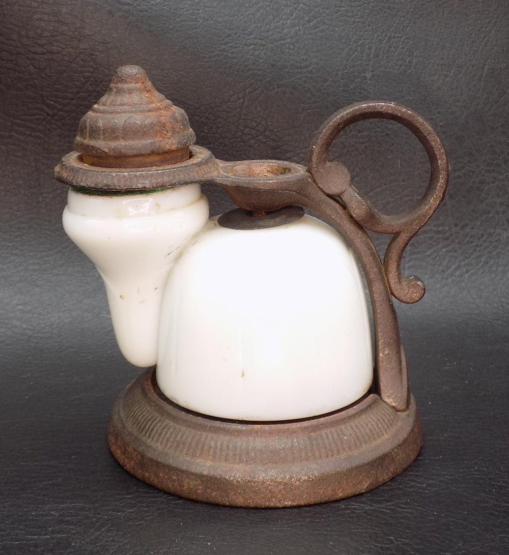 Unusual antique English inkwell: Unusual antique English inkwell. Ribbed milk glass. Cast iron frame. No maker markings. 3 5/8 inches tall.
