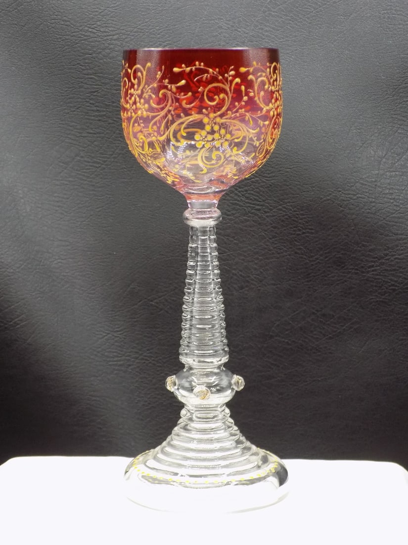 Fancy vintage Moser decorated wine glass.: Ornate vintage decorated Moser art glass wine glass. Cranberry to clear glass with gold enamel decoration. 7 ¾ inches tall x 2 ½ wide at top rim. In very good original as found condition