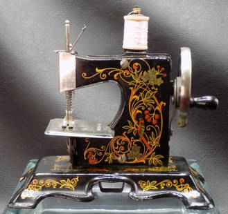 Fabulous vintage decorated childs sewing machine.: Fabulous vintage decorated childs sewing machine. Near Mint. Has box lid top only. Marked Made in Germany as shown in photo. Working condition . In very good original as found condition. Great quality