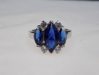 Beautiful sapphire and white topaz sterling silver ring.: Beautiful sapphire and white topaz sterling silver ring. Lab created sapphire. Size 6 &frac14;. Approx. 6 cwt. In very good original as found condition. Great quality and detail. For in house shipping