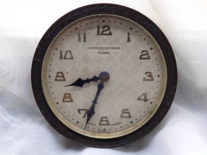 Antique  automobile clock.: Antique automobile clock. Removable from car to take in hotel or motel when on the road. Swiss made as shown in photo. Sandoz Vuille 8 Day marked on dial as shown in photo. Missing stem and do not kno