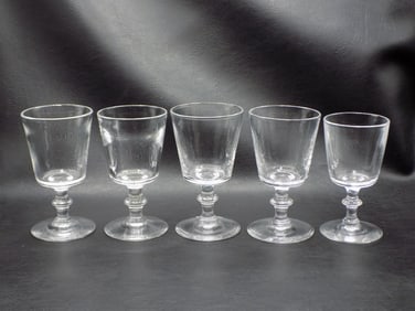Vintage set of four signed Stueben wine glasses and one smaller glass.