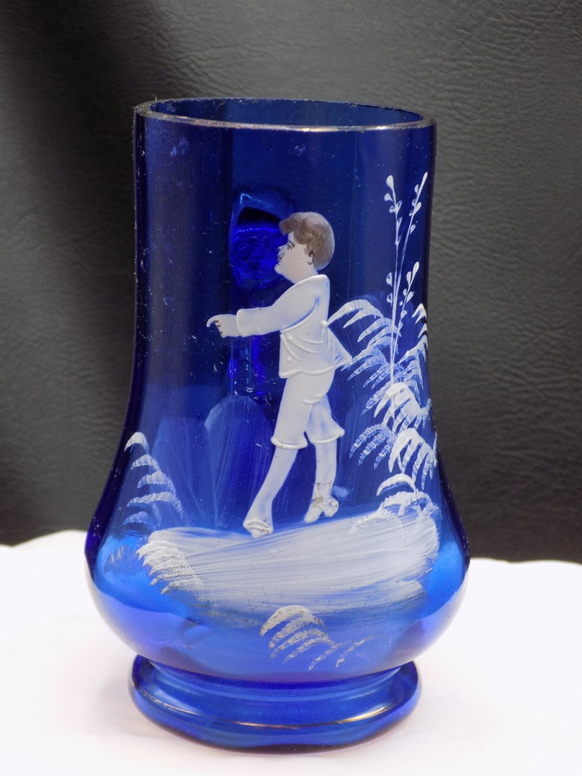 Vintage enamel decorated cobalt blue art glass mug: Vintage enamel decorated cobalt blue art glass mug. In very good original as found condition. Great quality and detail. 5 inches tall x 2 3/8 wide at top rim. White spots are camera flash reflection.