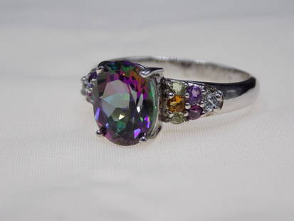 Beautiful 2 cwt rainbow topaz sterling silver ring.: Beautiful 2 cwt rainbow topaz sterling silver ring. Marked as shown in photo. Size 8 3/4. In very good original as found condition. Great quality and detail. For in house shipping. Please call Mike at